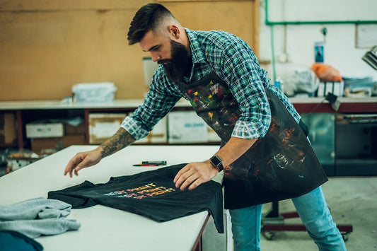 man folding recently pressed t-shirt