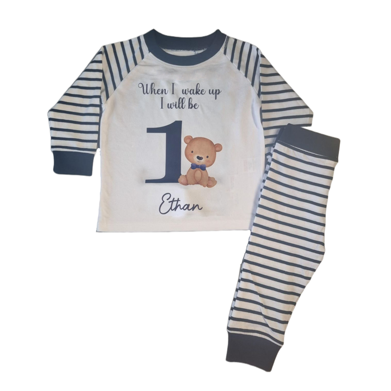 'When I wake up I will be' 1 navy and white stripe pyjamas with bear and blue bow tie, includes child's name, flat top and folded bottoms