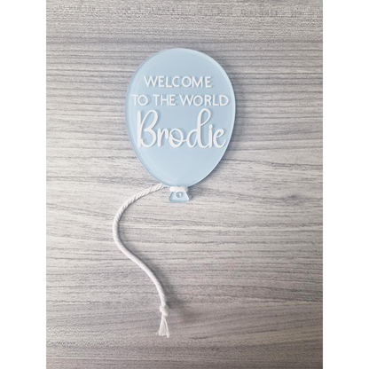 Pastel Blue painted balloon acrylic with Welcome To The World Brodie example