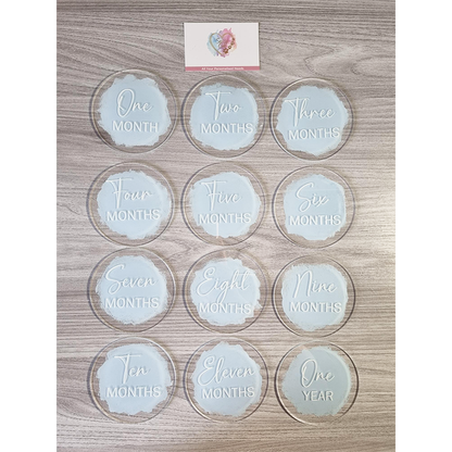 Set of 12 baby milestone discs ranging from 1 month to 1 year in pastel blue colour with white vinyl