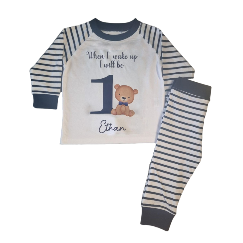 'When I wake up I will be' 1 navy and white stripe pyjamas with bear and blue bow tie, includes child's name, flat top and folded bottoms 
