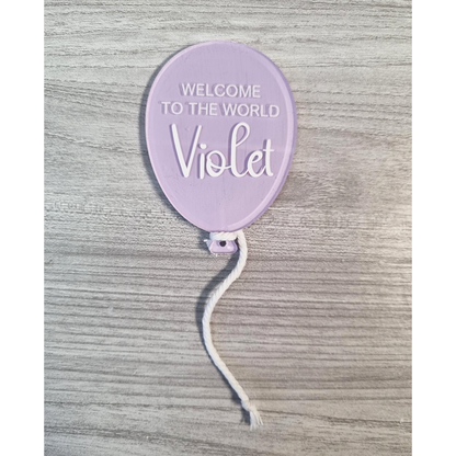 Purple painted balloon acrylic with Welcome To The World Violet example