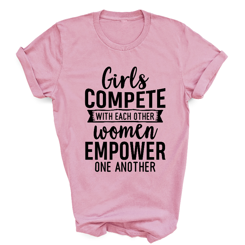 Girls Compete With Each Other Women Empower One Another Slogan Light Pink T-Shirt Black Text